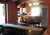 Open Kitchen & Dining Room are great for entertaining (in addition to the living room and giant entertainment room with a bar, fusbal, and pool table...) and opens  up to deck, jacuzzi, and private trails with boardwalk by the year around creek.