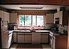 Full kitchen, including dishwasher, coffee maker, fridge, and 4 burner stove with oven.  All cookware and dishes provided for you, of course.