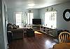 Living room in Main House. Chaise Lounge Couch, flat screen T.V. and lots of light!