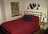 Master bedroom with queen bed and tv
