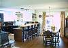 Dining Room opening to sundeck with bamboo floors, and then out to deck and backyard with room and BBQ