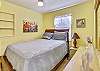 Queen size bed with posture-pedic mattress in guest bedroom