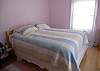 Upper level Queen size guest room with lots of natural light and views of the pool