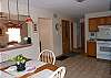 Kitchen area with table and seating for four.
