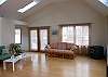 Living room with cathedral ceilings also access to deck area.