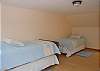 Bedroom on upper floor with 2 trundle beds equalling four twin beds.