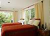 Bedroom 3 has 2 Twin beds that easily convert to a King bed with a special wedge.  The bedroom is on the bottom level and has ensuite bathroom and 3 large windows with views of the rainforest at Casa Infinito luxury vacation rental home at Valle Perdido in Playa Hermosa, Costa Rica