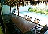 Pool and palm thatched terrace with table for 10 guests and gas grill at Casa Gris vacation rental house in Jaco, Costa Rica