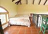 Loft with Queen bed and table at the guesthouse of Villa Oceana vacation rental in Esterillos Este, halfway between Jaco and Manuel Antonio, Costa Rica