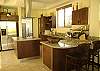 We can see the laundry room and the elegant fully equipped kitchen  at Casa La Ostra vacation rental house in the exclusive Hermosa Palms beachfront gated community, Playa Hermosa, Costa Rica