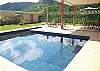 Mirror-like swimming pool reflects the clouds at Casa Las Monas vacation rental house near Jaco, Costa Rica