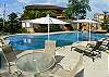 Pool area with lounge chairs and table at La Flor beachfront gated community on the North side of Jaco beach Costa Rica