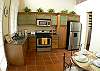 Full kitchen with stainless steell appliances and dining table for four people inside the guesthouse at Villa Oceana vacation rental home in Esterillos, Costa Rica, half way between Jaco and Manuel Antonio.