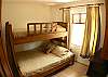 Third bedroom (on first floor) with beautiful wooden bunk bed with Full and Twin size beds and dresser.  Full bathroom is opposite.  Rio Copey 2 vacation rental townhouse in Jaco, Costa Rica.
