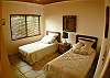 Bedroom with 2 twin beds, shares bathroom on hallway, located in the ground floor, just off the living area at Casa de Somers vacation rental in Esterillos near Manuel Antonio.