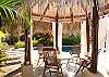Palm thatched gazebo and pool at Casa Milagro beachfront vacation rental house in Jaco, Costa Rica