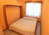 Bedroom 4 with Queen bed off the living room downstairs (shares bathroom) at Casa Miguel vacation rental house in Jaco, Costa Rica, 8 minute walk to the beach and downtown.