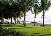 Perfectly trimmed bermuda grass between the villa and the beach complemented by two hammocks hanging from a few lazy palm trees, compliments of Hermosa Palms Villa La Costa luxury vacation rental in Playa Hermosa, near Jaco, Costa Rica