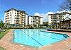 Large pool with plenty of lounge chairs and umbrellas at Costa Linda vacation rental condominiums in Jaco, walking distance to the beach.