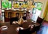 Dining table for 8 guests, next to breakfast bar for 5 guests, at Villa Antigua luxury vacation rental home in south Jaco beach, Costa Rica
