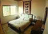 Bedroom with Double bed and closet, located on ground floor, next to bathroom on hallway at Casa de Somers vacation rental in Esterillos near Manuel Antonio.
