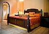 Master Bedroom (ground floor) with King bed, ensuite bathroom, walk-in closet, safe and 40 inch LCD TV, that opens to the courtyard at Villa Antigua luxury vacation rental home in south Jaco beach, Costa Rica