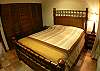 Second bedroom with wood and bamboo Queen bed, black-out curtains and ample closet at Casa Colonial in Hermosa Palms gated community in Playa Hermosa, Costa Rica