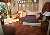 This room has a queen bed, bathroroom and a private terrace with view to the garden at Sonidos del Rio, Vacation Rental, Jaco costa Rica.