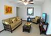Living area with plush seating and a 32 inch LCD TV at Costa Linda vacation rental condo 8-7 in Jaco, walking distance to the beach.