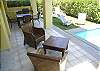 Poolside tiled terrace with seating and gas grill at Casa La Ostra vacation rental house in the exclusive Hermosa Palms beachfront gated community, Playa Hermosa, Costa Rica