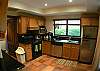 Fully equipped Kitchen with granite counter top, dishwasher, ceramic stove top and adjacent laundry room with washer and dryer, at Casa Colonial at Hermosa Palms gated community in Playa Hermosa, Costa Rica