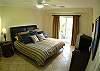 Master Bedroom with King bed, TV, black-out curtains, large closet and ensuite bathroom, at Del Mar 5N vacation rental condo at Los Suenos Resort & Marina, Playa Herradura, Costa Rica