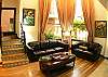 Living area with leather sofas and flat panel TV at La Flor del Paraiso vacation rental at La Flor beachfront gated community on the North side of Jaco beach Costa Rica