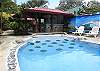 View of the pool and BBQ area.  The entrance to the pool is sloped and has natural stones both outside and under water.  These serve you to stand on them to relax by the edge of the pool.