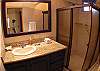 Ensuite bathroom with granite countertop and shower within bedroom overlooking the garden at Casa Miguel vacation rental in Jaco, Costa Rica, 8 minutes walking distance to beach and main street.