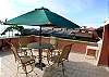Large outdoor ocean view Terrace with table, chairs, large umbrella and lounge chairs at our MarArena beachfront vacation rental penthouse condo in Jaco, Costa Rica