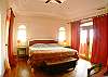 Master Bedroom with King bed, high ceilings, wood flooring, balconies overlooking the Pacific and the rainforest mountains, ensuite bathroom with walk-in closet at the main house of Villa Oceana vacation rental in Esterillos Este, halfway between Jaco and Manuel Antonio, Costa Rica