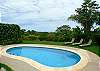 Pool area with ocean view and lounge chairs at Casa Exotica vacation rental home in Esterillos, Costa Rica, near Manuel Antonio and Jaco.
