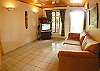 Comfortable couch in the living room with central AC, TV, DVD and wireless Internet at Villa Jaco Sol vacation rental, in Jaco, Costa Rica.