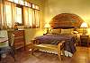 This room has a queen bed, bathroroom and a private terrace with view to the garden at Sonidos del Rio, Vacation Rental, Jaco costa Rica.