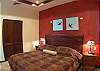 Master Bedroom with King bed, black-out curtains, ensuite bathroom and armoire on Second Floor at Casa Tortuga vacation rental home at Hermosa Palms in Playa Hermosa, Puntarenas, Costa Rica
