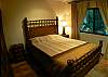 Second bedroom with wood and bamboo frame Queen bed, black out curtains and ample closet at Casa Colonial in Hermosa Palms gated community in Playa Hermosa, Costa Rica