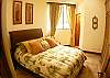 Second bedroom with Queen bed, black-out curtains, closet and ensuite bathroom at Hermosa Palms Villa La Costa vacation luxury rental in Playa Hermosa, Costa Rica