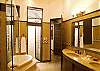 Master Bathroom with separate jetted bathtub and shower, double sink with marble counter and walk-in closet, at Hermosa Palms Villa La Costa vacation luxury rental in Playa Hermosa, Costa Rica.