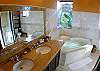 Master Bathroom with double sink, marble counter, jetted bathtub and two showers, indoor and outdoor, at Casa Tortuga vacation rental house at Hermosa Palms in Playa Hermosa, Puntarenas, Costa Rica