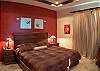 Master Bedroom with King bed, black-out curtains, ensuite bathroom and armoire on Second Floor at Casa Tortuga vacation rental home at Hermosa Palms in Playa Hermosa, Puntarenas, Costa Rica