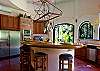 Kitchen with breakfast island and stainless steel high-end appliances at Villa Antigua luxury vacation rental home in south Jaco beach, Costa Rica