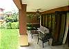 Ground floor terrace with comfortable seating and coffee table overlooking the garden at La Flor del Paraiso vacation rental home at La Flor beachfront gated community on the North side of Jaco beach Costa Rica