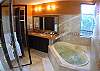 Master Bathroom with double sink, marble counter, jetted bathtub and two showers, indoor and outdoor, at Casa Tortuga vacation rental house at Hermosa Palms in Playa Hermosa, Puntarenas, Costa Rica