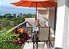 Balcony with table and chairs at Jaco Bay 4701 vacation rental condominiums in Jaco beach. The umbrella is no longer available for security reasons.